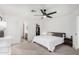 Well-lit bedroom with a ceiling fan, closet, and ensuite bathroom at 11843 W Cambridge Ave, Avondale, AZ 85392