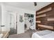 Cozy bedroom showcases a wood accent wall and closet with baby clothes at 11843 W Cambridge Ave, Avondale, AZ 85392