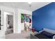 Bedroom boasts a blue accent wall, closet, and an open doorway at 11843 W Cambridge Ave, Avondale, AZ 85392