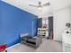 Bright bedroom featuring a blue accent wall, ceiling fan, and ' toys at 11843 W Cambridge Ave, Avondale, AZ 85392