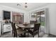 Cozy dining room featuring a rustic table and chairs, a sliding glass door, and backyard views at 11843 W Cambridge Ave, Avondale, AZ 85392