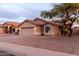 Charming single-story home featuring a two-car garage, neutral stucco, and low-maintenance desert landscaping at 11843 W Cambridge Ave, Avondale, AZ 85392