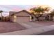 Charming single-story home featuring a two-car garage, neutral stucco, and low-maintenance desert landscaping at 11843 W Cambridge Ave, Avondale, AZ 85392