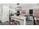 Bright kitchen featuring stainless steel appliances, an island with seating, and a stylish pendant light fixture at 11843 W Cambridge Ave, Avondale, AZ 85392