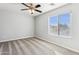 Bright bedroom features neutral carpet, ceiling fan and a window allowing natural light at 1200 E Country Crossing Way, San Tan Valley, AZ 85143