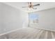 Bright bedroom features neutral carpet, ceiling fan and a window allowing natural light at 1200 E Country Crossing Way, San Tan Valley, AZ 85143