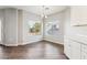 Bright dining area featuring wood-look floors, neutral walls, a modern chandelier, and large windows at 1200 E Country Crossing Way, San Tan Valley, AZ 85143