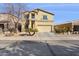 Welcoming two-story home featuring a neutral stucco exterior, neat landscaping, and an attached two-car garage at 1200 E Country Crossing Way, San Tan Valley, AZ 85143