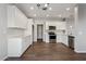 Modern kitchen featuring stainless steel appliances, white cabinets, quartz countertops, and wood-look flooring at 1200 E Country Crossing Way, San Tan Valley, AZ 85143