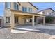 Outdoor living space with covered patio, ceiling fans, large concrete pad, and gravel landscaping at 1200 E Country Crossing Way, San Tan Valley, AZ 85143