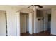 Bedroom with hardwood floors and closet with bifold doors at 12245 N 21St Ave # 4, Phoenix, AZ 85029