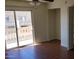 Living room with hardwood floors and sliding glass doors to a balcony at 12245 N 21St Ave # 4, Phoenix, AZ 85029