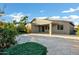 Expansive backyard with a covered patio, travertine pavers, manicured landscaping and outdoor living space at 123 W Sweet Shrub Ave, San Tan Valley, AZ 85140