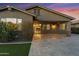 Backyard at dusk featuring a covered patio, paver flooring, and mature landscaping at 123 W Sweet Shrub Ave, San Tan Valley, AZ 85140