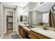 Dual vanities with granite countertops in a bathroom with a walk-in closet at 123 W Sweet Shrub Ave, San Tan Valley, AZ 85140