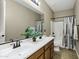 Bathroom featuring double sinks, shower-tub combo and ample counter space at 123 W Sweet Shrub Ave, San Tan Valley, AZ 85140