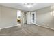 Bright, carpeted bedroom with an open doorway leading to an en-suite bathroom at 123 W Sweet Shrub Ave, San Tan Valley, AZ 85140