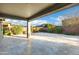 Large covered patio with stone tile flooring, offering a perfect spot for outdoor entertaining and relaxation at 123 W Sweet Shrub Ave, San Tan Valley, AZ 85140