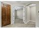 Warm foyer with tile flooring and view into a carpeted bedroom through double doors at 123 W Sweet Shrub Ave, San Tan Valley, AZ 85140