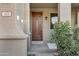 Inviting front entrance with a solid wood door and decorative sidelight window at 123 W Sweet Shrub Ave, San Tan Valley, AZ 85140