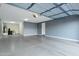 Spacious garage with epoxy flooring, ample lighting, and a modern garage door system at 123 W Sweet Shrub Ave, San Tan Valley, AZ 85140