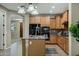 Well-lit kitchen with stainless steel appliances, granite countertops, and a practical kitchen island at 123 W Sweet Shrub Ave, San Tan Valley, AZ 85140