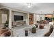 Spacious living room showcasing a media center, ceiling fan, and adjacent dining area at 123 W Sweet Shrub Ave, San Tan Valley, AZ 85140