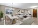 Bright living room featuring a dining area, a comfortable sofa, and neutral tones at 123 W Sweet Shrub Ave, San Tan Valley, AZ 85140