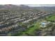 Expansive aerial view showcasing a well-planned community with homes, green spaces, and a central recreation area at 12551 W Parkway Ln, Avondale, AZ 85323