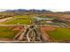 Aerial view showcasing the community park with baseball fields, tennis courts, a playground, and a serene pond at 12551 W Parkway Ln, Avondale, AZ 85323