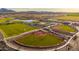 Aerial shot captures the community park featuring amenities like tennis courts, a lake, playground and more at 12551 W Parkway Ln, Avondale, AZ 85323