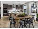 Modern kitchen featuring stainless steel appliances, an island with seating, and an adjacent dining area at 12551 W Parkway Ln, Avondale, AZ 85323