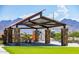 Community picnic area with stone pillars, shade canopy, and mountain view at 12551 W Parkway Ln, Avondale, AZ 85323