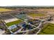 Expansive aerial shot of a community park featuring baseball fields, tennis courts, and a splash pad at 12647 W Parkway Ln, Avondale, AZ 85323