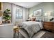 Cozy bedroom featuring stylish decor, a patterned comforter, and views from a window at 12647 W Parkway Ln, Avondale, AZ 85323