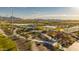 Scenic aerial view of a community park with a playground, lake, ramadas and mountain views at 12647 W Parkway Ln, Avondale, AZ 85323