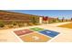 Colorful hopscotch game and butterfly benches enhance a community park, promoting active and creative outdoor play at 12647 W Parkway Ln, Avondale, AZ 85323