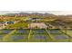 Aerial view of pickleball courts, basketball court, and pond in a well-maintained community park at 12647 W Parkway Ln, Avondale, AZ 85323