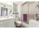 Well-lit bathroom with a single sink, tiled floors, and a glass-enclosed shower for a modern touch at 13019 N 98Th Ave, Sun City, AZ 85351