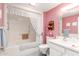 Charming bathroom featuring a bathtub with a shower, tiled floors, and a decorative lace shower curtain at 13019 N 98Th Ave, Sun City, AZ 85351