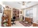 Relaxing room featuring a bookcase, natural light, and hardwood floors that create a welcoming space at 13019 N 98Th Ave, Sun City, AZ 85351