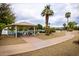 Picturesque gazebo near the water offers seating and shade, surrounded by desert landscaping and walking paths at 13019 N 98Th Ave, Sun City, AZ 85351