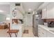 Functional kitchen featuring white cabinets, stainless steel appliances, and a breakfast bar at 13019 N 98Th Ave, Sun City, AZ 85351