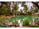 Picturesque pond with rocks, trees, waterfall, and gazebo at 13019 N 98Th Ave, Sun City, AZ 85351