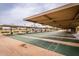 Outdoor shuffleboard courts under a covered pavilion provides ample space for recreation at 13019 N 98Th Ave, Sun City, AZ 85351