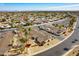 Aerial view of a Sun City West neighborhood showcases desert landscaping, and well-maintained homes and streets at 13404 W Copperstone Dr, Sun City West, AZ 85375