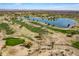 Beautiful aerial view of a desert golf course with a scenic lake and mountain views at 13404 W Copperstone Dr, Sun City West, AZ 85375