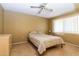 This bedroom has a bed, ceiling fan, and a window at 13404 W Copperstone Dr, Sun City West, AZ 85375