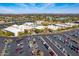 Aerial view of a Sun City West community center with pools, parking, and picturesque mountain views at 13404 W Copperstone Dr, Sun City West, AZ 85375