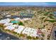 Aerial view of community center with pools, golf course and picturesque mountain views, parking and lush landscaping at 13404 W Copperstone Dr, Sun City West, AZ 85375